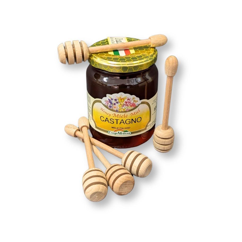 Prendimiele in legno di faggio adiacenti a vasetto di miele